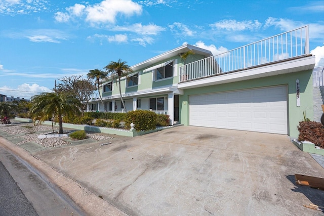 view of front of home featuring a garage and a balcony