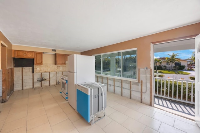 kitchen featuring white appliances and light tile patterned floors