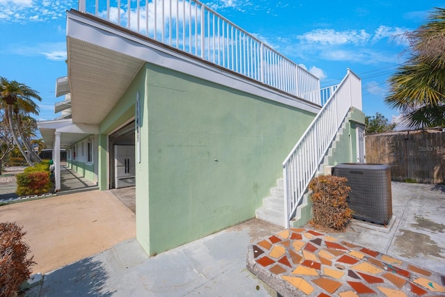 view of side of property featuring cooling unit and a patio