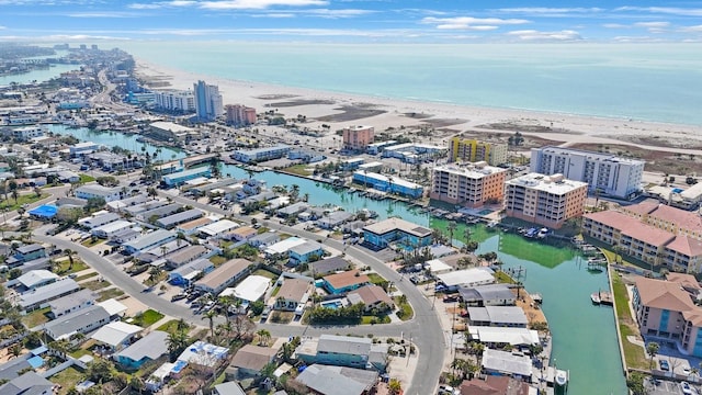 birds eye view of property with a water view and a beach view