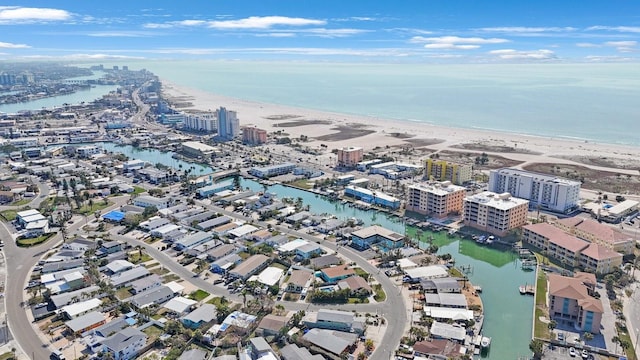 drone / aerial view featuring a water view and a view of the beach