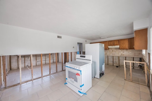 kitchen featuring light tile patterned floors and white appliances