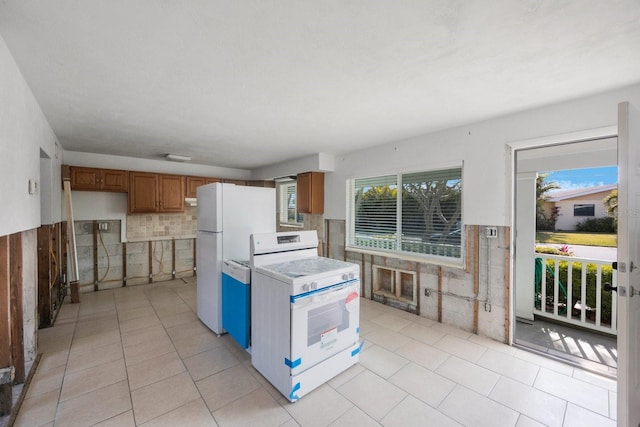 kitchen featuring light tile patterned flooring and white appliances