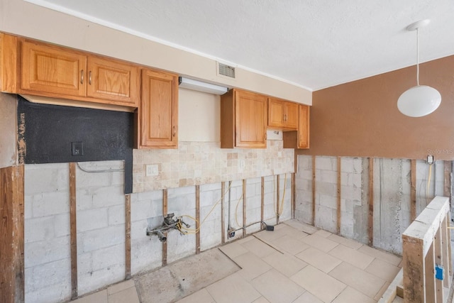 kitchen featuring hanging light fixtures and a textured ceiling