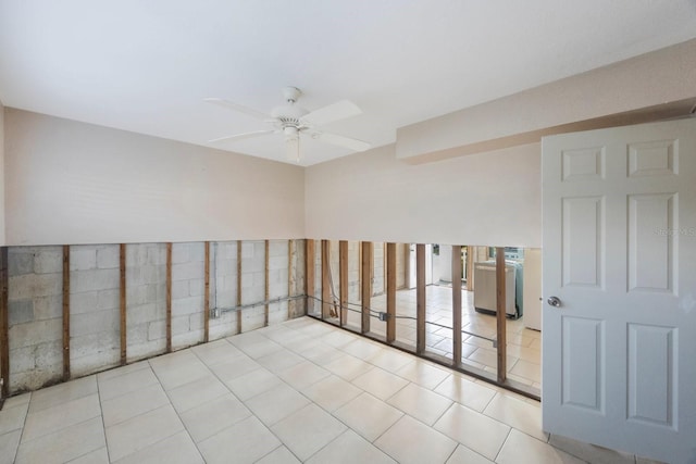 tiled spare room with ceiling fan