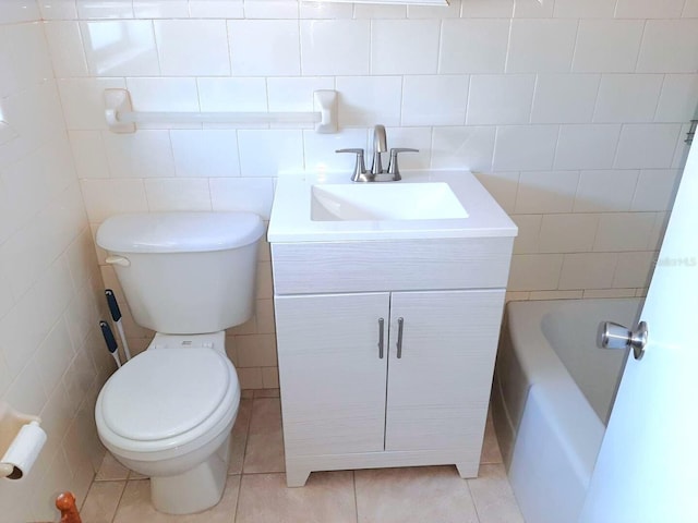 bathroom featuring vanity, toilet, tile patterned flooring, and tile walls