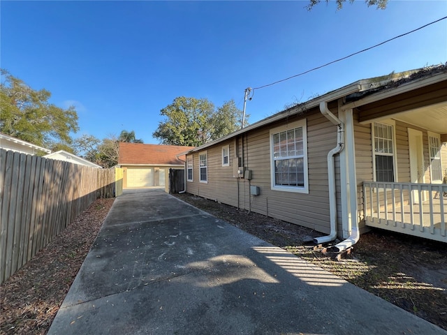 view of side of property featuring an outbuilding and a garage