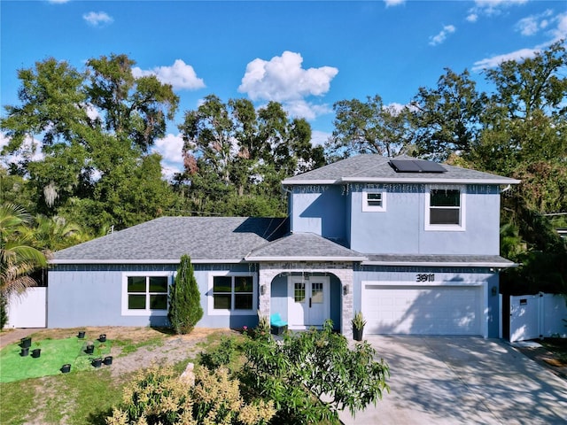 front of property featuring a garage and solar panels