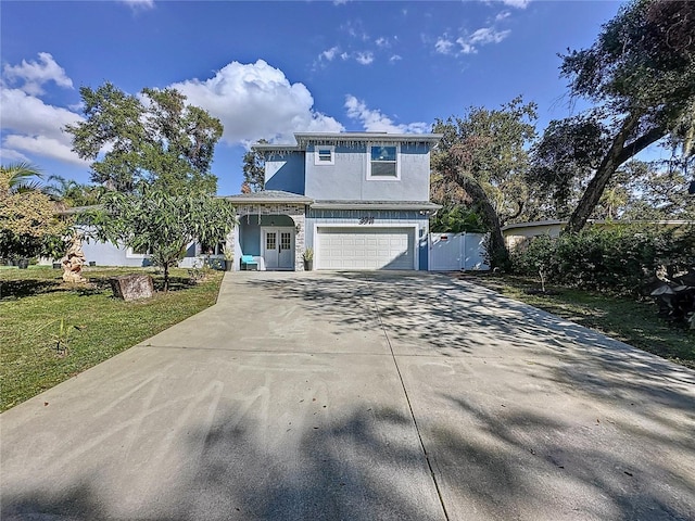 front facade featuring a garage and a front yard