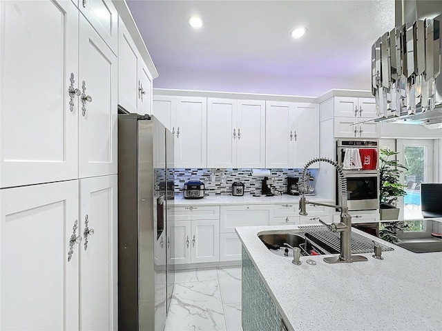 3911 Auburndale Ave, Orlando, FL 32839 - kitchen with white cabinetry, backsplash, light stone counters, and appliances with stainless steel finishes