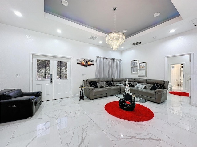 3911 Auburndale Ave, Orlando, FL 32839 - living room with french doors, a high ceiling, a chandelier, and a tray ceiling