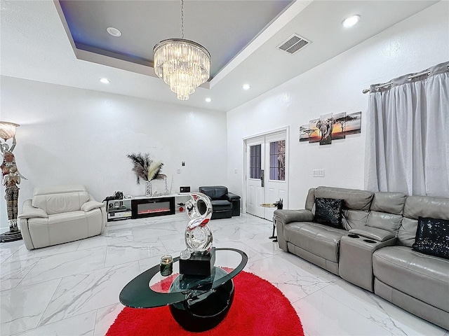 3911 Auburndale Ave, Orlando, FL 32839 - living room featuring an inviting chandelier, a tray ceiling, and french doors
