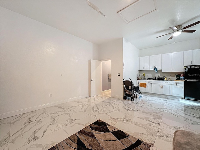 3911 Auburndale Ave, Orlando, FL 32839 - kitchen with white cabinetry, black fridge, and ceiling fan