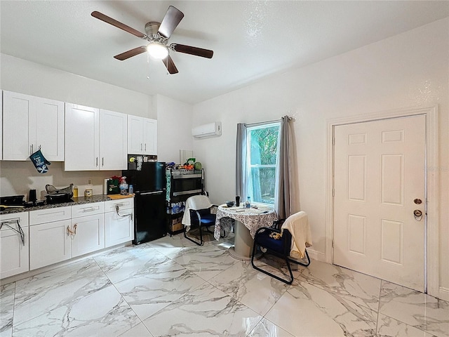3911 Auburndale Ave, Orlando, FL 32839 - kitchen with white cabinetry, an AC wall unit, ceiling fan, and black fridge