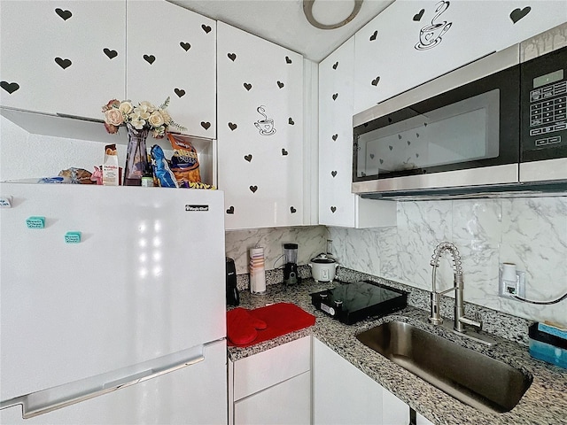 3911 Auburndale Ave, Orlando, FL 32839 - kitchen featuring sink, backsplash, white cabinets, and white refrigerator