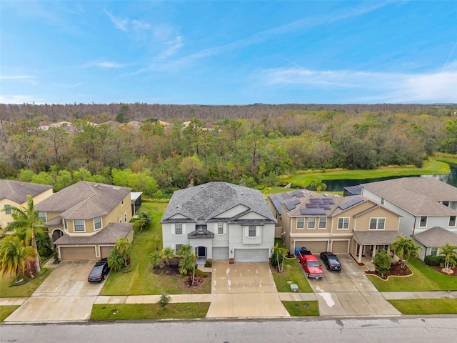 bird's eye view featuring a residential view and a wooded view