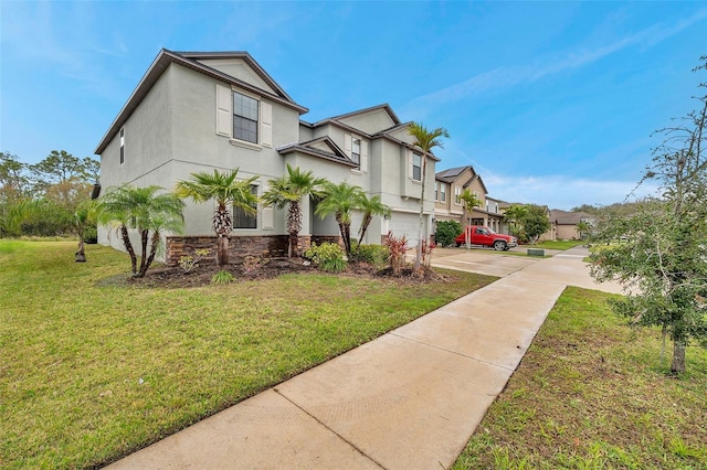 view of front of home with stucco siding, an attached garage, a residential view, driveway, and a front lawn