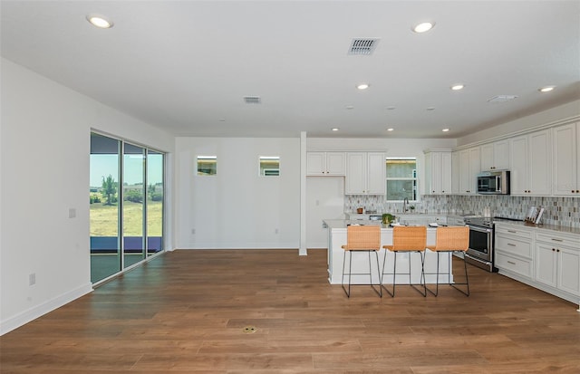 5295 SW 87th Ter, Ocala, FL 34481 - kitchen with appliances with stainless steel finishes, recessed lighting, tasteful backsplash, white cabinets, and a center island