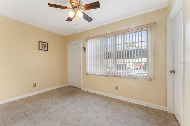 spare room with ceiling fan