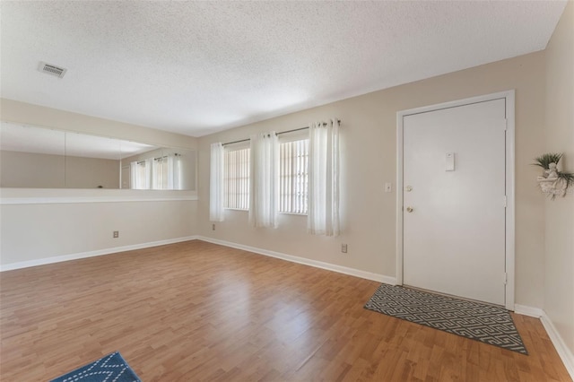 entryway featuring hardwood / wood-style floors and a textured ceiling