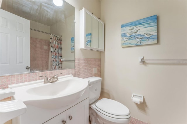 bathroom with vanity, a shower with curtain, and toilet