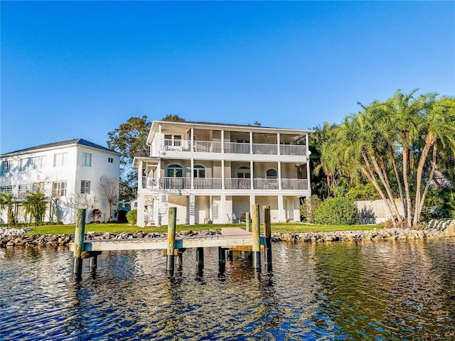 back of house featuring a balcony and a water view