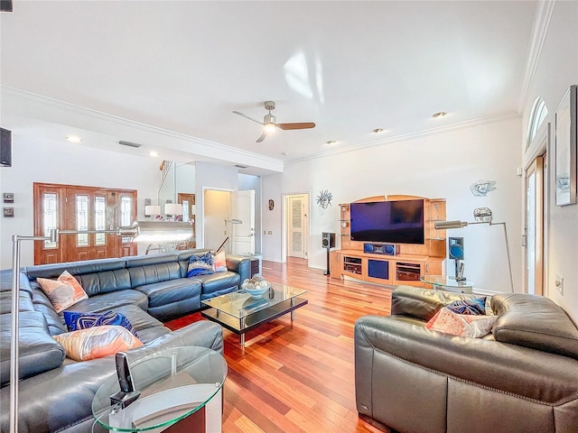 living room with ornamental molding, light hardwood / wood-style floors, and ceiling fan