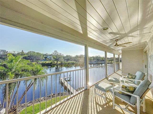 balcony with a water view and ceiling fan