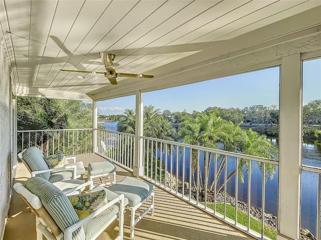 balcony with a water view and ceiling fan