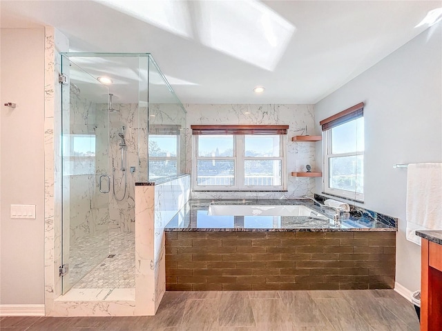 bathroom with vanity and separate shower and tub