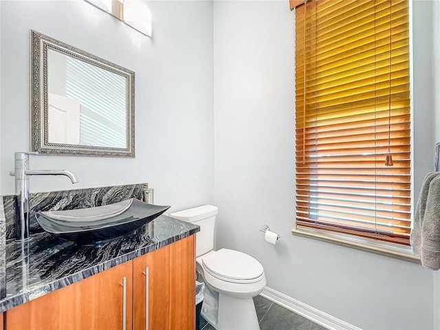 bathroom featuring tile patterned floors, vanity, and toilet