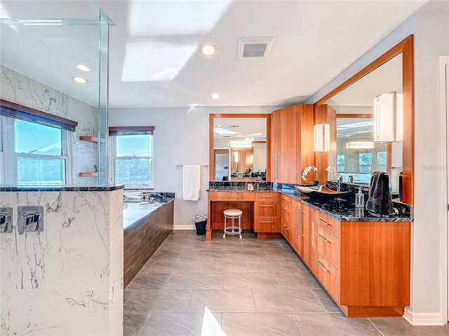 kitchen with dark stone countertops and kitchen peninsula