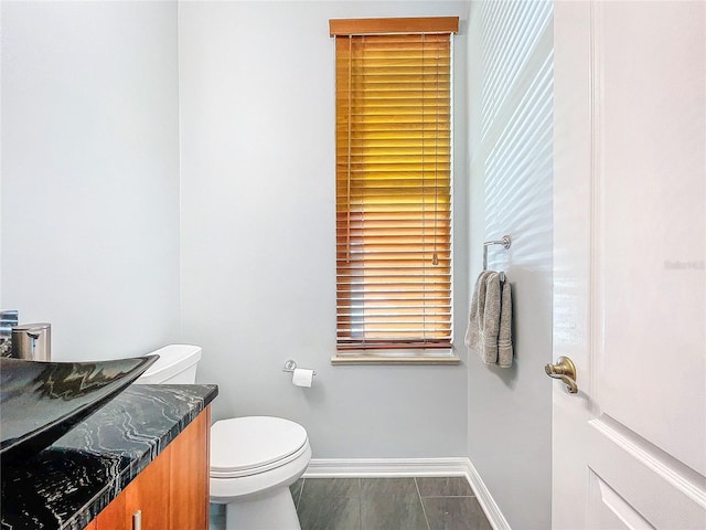 bathroom featuring vanity, wood-type flooring, and toilet