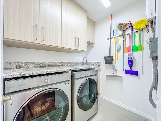 laundry room featuring cabinets and washer and dryer