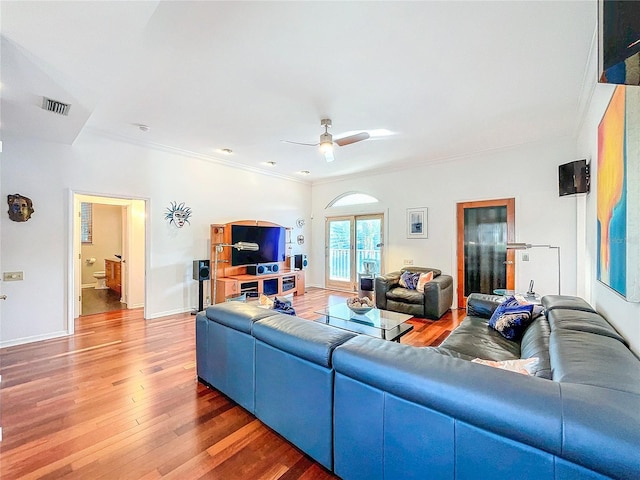 living room featuring crown molding, wood-type flooring, and ceiling fan