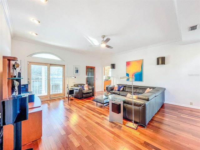 living room featuring wood-type flooring, ornamental molding, and ceiling fan