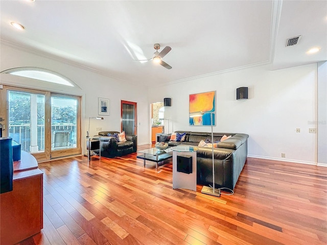 living room featuring ceiling fan, ornamental molding, and hardwood / wood-style floors