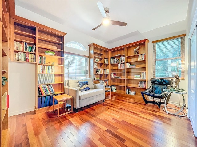 living area with hardwood / wood-style flooring and ceiling fan