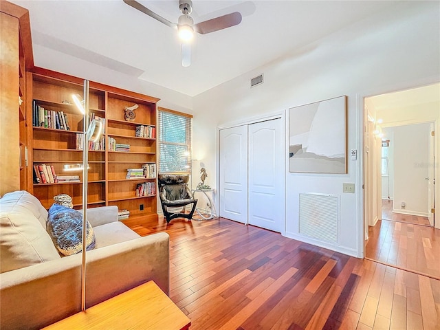 living room featuring ceiling fan and hardwood / wood-style floors