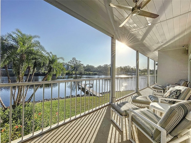 balcony with ceiling fan and a water view