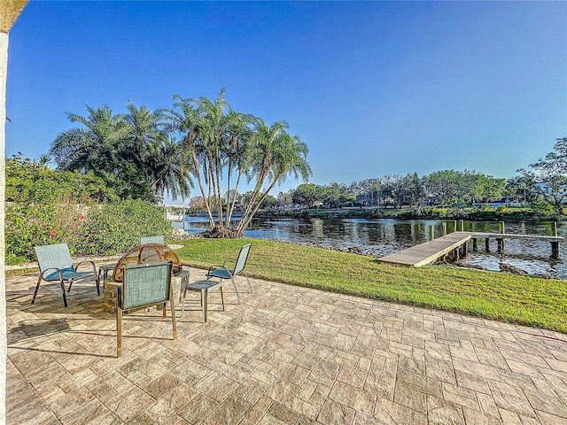 view of patio / terrace with a dock and a water view