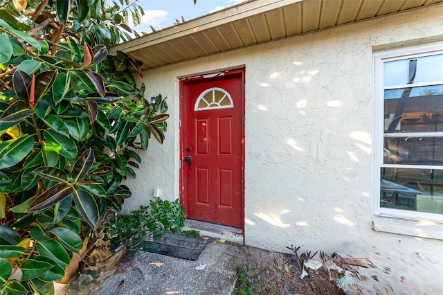 entrance to property with stucco siding