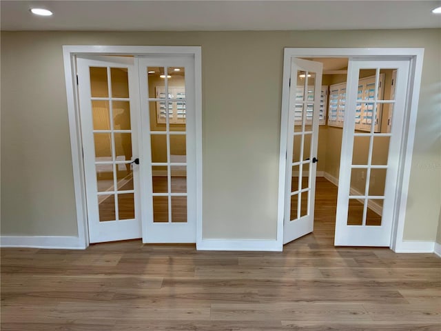 interior space with french doors and light wood-type flooring