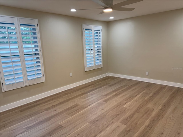 unfurnished room with ceiling fan, plenty of natural light, and light wood-type flooring