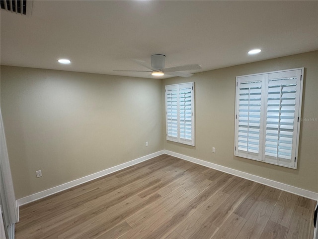 empty room featuring ceiling fan and light wood-type flooring