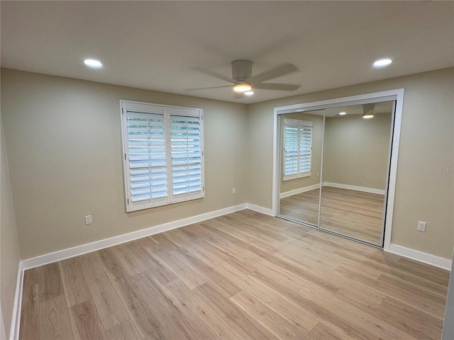 unfurnished bedroom with ceiling fan, light hardwood / wood-style floors, and a closet