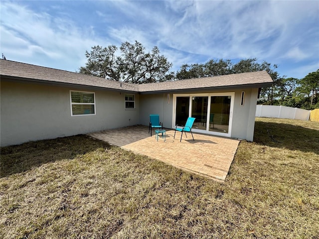 rear view of property with a lawn and a patio area