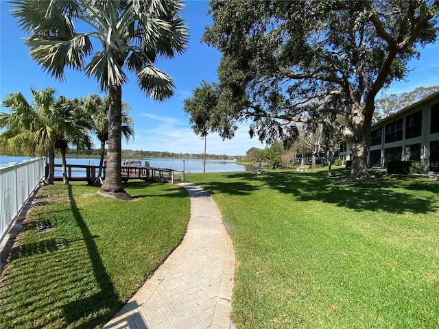 view of community featuring a lawn and a water view