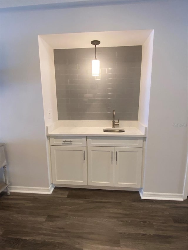 bathroom with hardwood / wood-style flooring, vanity, and backsplash