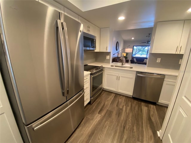 kitchen featuring white cabinetry, sink, dark hardwood / wood-style flooring, and appliances with stainless steel finishes